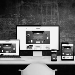 Responsive website design displayed across multiple devices - laptop, desktop monitor, tablet, and smartphone